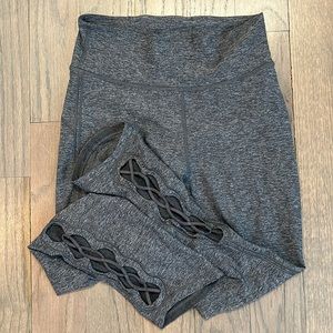 Grey Lululemon leggings, high waisted with ribbing at the bottom. No pockets.